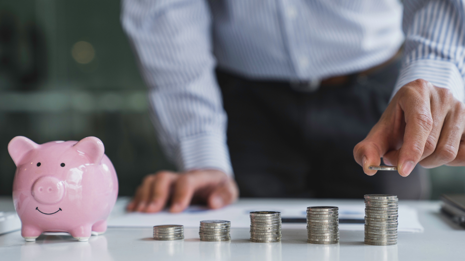 pink piggy bank next to coins