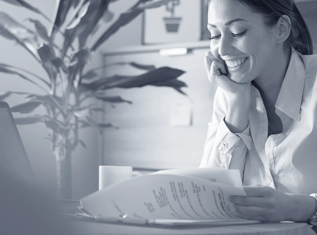 happy-female-entrepreneur-analyzing-business-reports-feeling-satisfied-about-business-progress